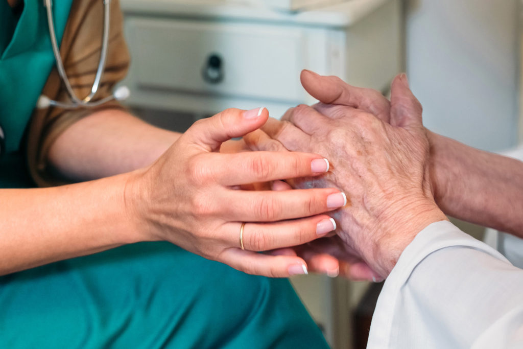 Doctor giving encouragement to elderly patient